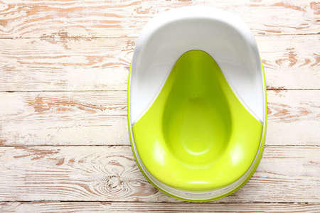 Baby potty on wooden backgroundの写真素材