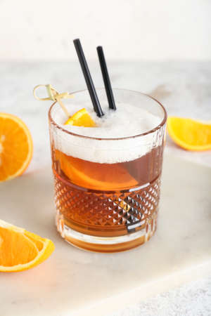 Glass of tasty whiskey sour cocktail on light background