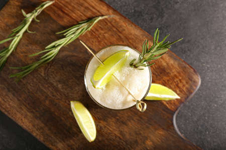 Glass of tasty whiskey sour cocktail on dark backgroundの写真素材