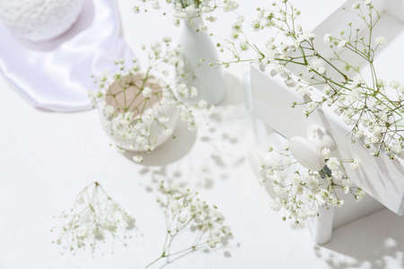 Wooden boxes with beautiful gypsophila flowers on light table, closeupの写真素材