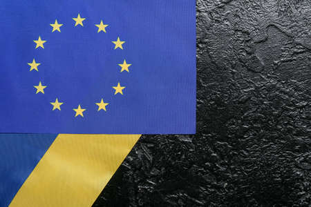Flags of European Union and Ukraine on black background