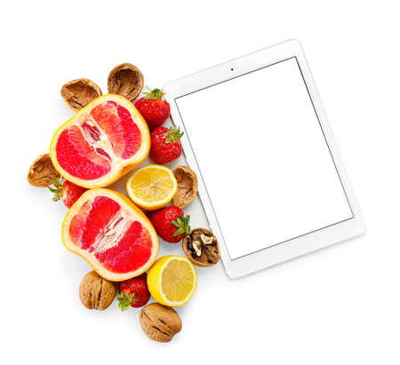 Digital recipe book, walnuts, grapefruit, lemon and strawberry on white background