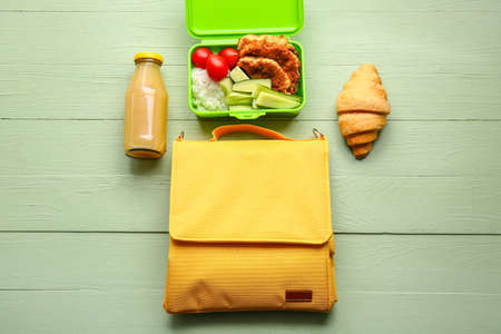 Lunch box bag and food on color wooden backgroundの写真素材