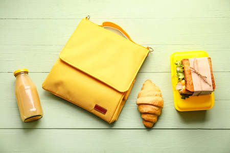 Lunch box bag and food on color wooden backgroundの写真素材