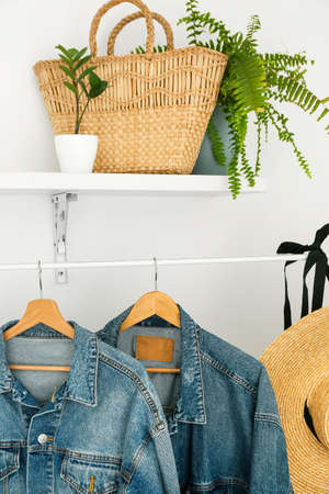 Rack with denim jackets near light wall in modern hallwayの写真素材