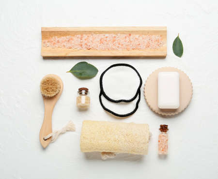 Different bath supplies with reusable cotton pads and sea salt on light backgroundの写真素材