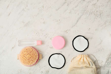 Different bath supplies and reusable makeup pads on light backgroundの写真素材