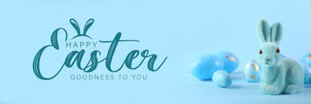 Beautiful Easter greeting card with toy bunny and eggs in light blue colors