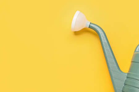 Watering can on color background