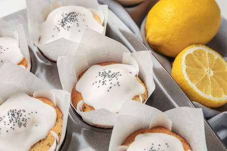 Baking tin with delicious glazed poppy seed muffins, closeupの写真素材