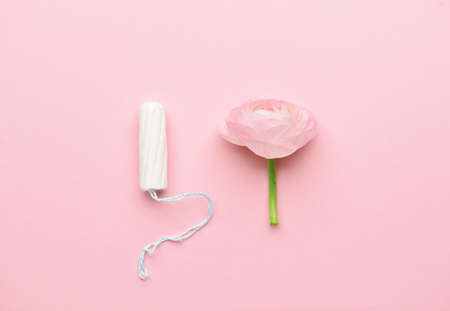Tampon and flower on color backgroundの写真素材