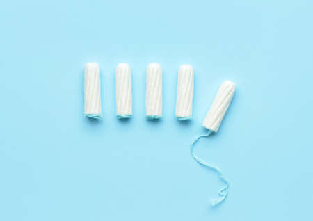 Tampons on color background, top view