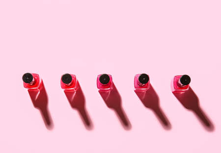 Bottles of nail polishes on color background