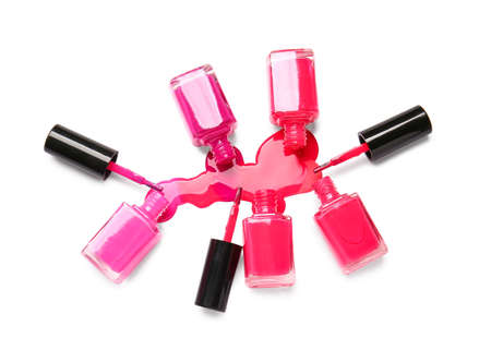 Bottles of nail polishes with brushes and blot on white backgroundの写真素材