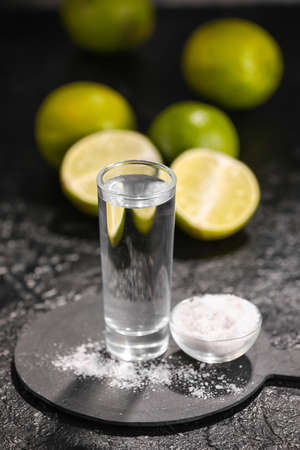 Shot of tasty tequila with lime and salt on dark background, closeupの写真素材