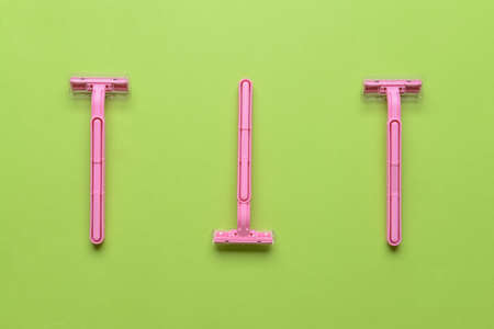 Safety razors on green background