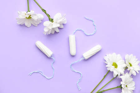 Menstrual tampons and flowers on color backgroundの写真素材