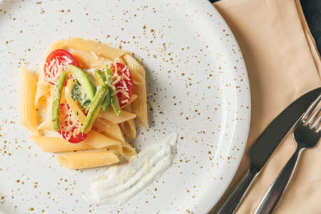Plate of tasty pasta with vegetables, closeup