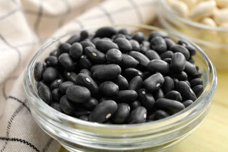 Bowl with raw beans on color wooden background, closeupの写真素材