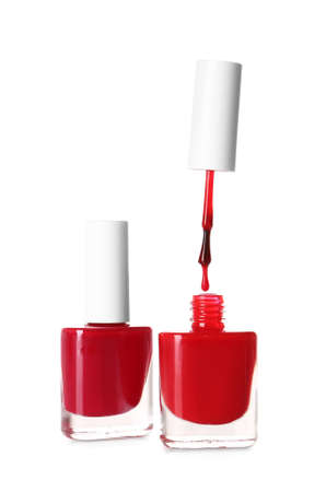 Bottles and brush with dripping nail polish on white backgroundの写真素材