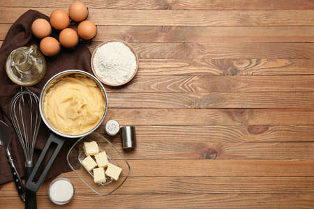 Ingredients for preparing churros on wooden background