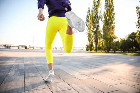 Sporty young woman running outdoorsの写真素材