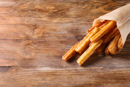 Tasty churros on wooden backgroundの写真素材