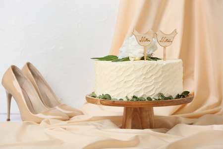 Dessert stand with beautiful wedding cake on tableの写真素材