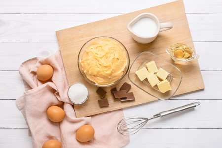 Ingredients for preparing churros on light wooden background