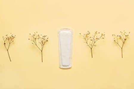 Menstrual pad and flowers on yellow backgroundの写真素材