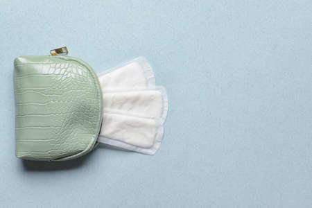 Cosmetic bag with menstrual pads on color backgroundの写真素材
