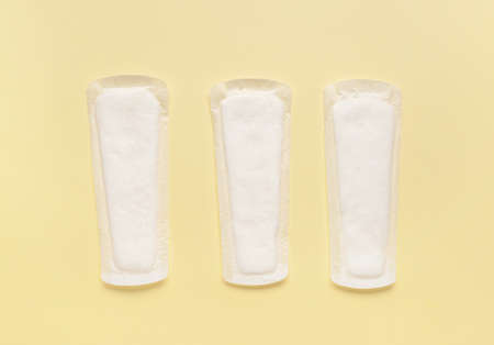 Menstrual pads on yellow background