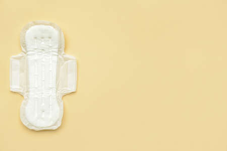 Menstrual pad on yellow background