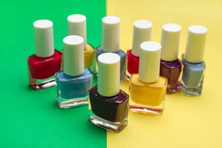 Set of nail polish bottles on color backgroundの写真素材