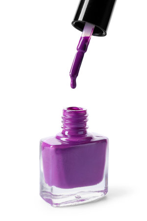 Nail polish dripping from brush on white backgroundの写真素材