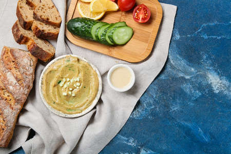 Bowl with tasty baba ghanoush and fresh products on color backgroundの写真素材