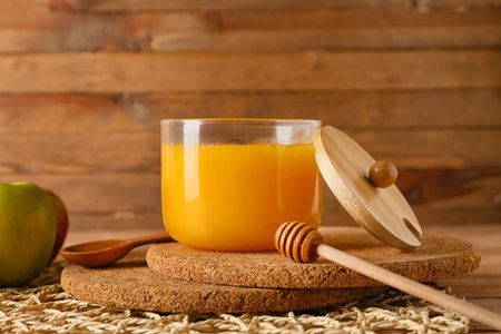 Jar of honey on wooden background, closeupの写真素材
