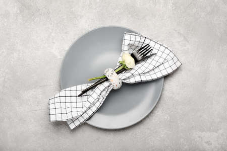 Stylish table setting and ranunculus flower on light background