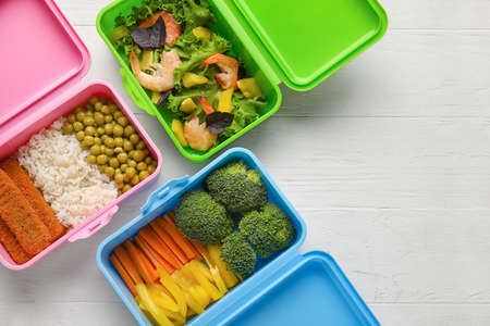 Containers with healthy food on white wooden background, closeupの写真素材