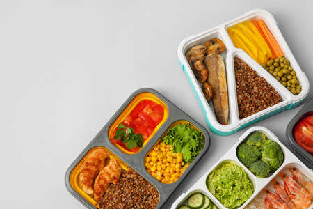 Different containers with healthy food on light background, closeupの写真素材