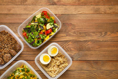 Containers with healthy food on wooden backgroundの写真素材