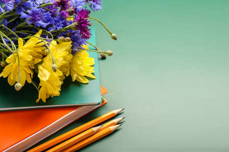 Beautiful flowers and stationery on color background. teacher's day celebration