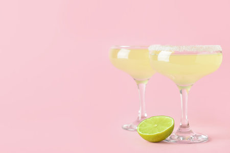 Glasses with tasty daiquiri cocktail on color backgroundの写真素材