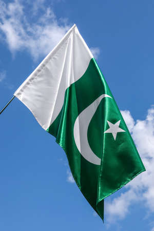 Pakistan flag outdoors against blue sky