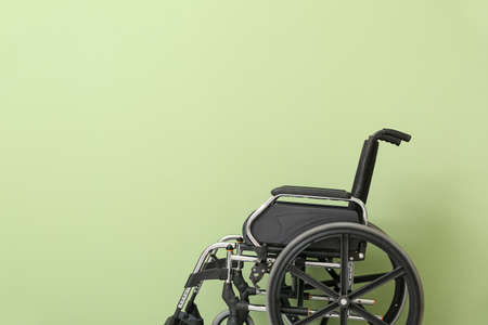 Empty wheelchair on color backgroundの写真素材