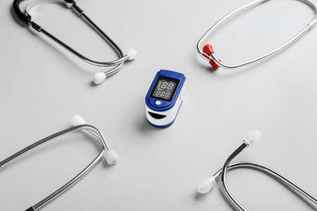 Pulse oximeter and stethoscopes on light backgroundの写真素材