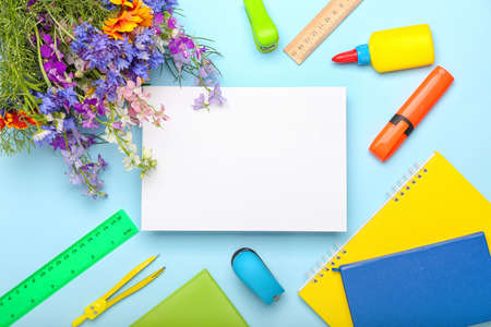 Blank sheet of paper, flowers and stationery on color background, closeupの写真素材