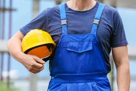 Male worker with safety hardhat at construction siteの写真素材