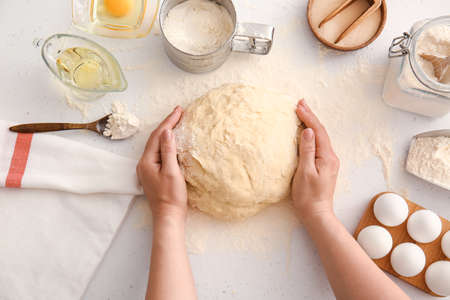 Woman preparing dough on kitchen table, closeupの写真素材