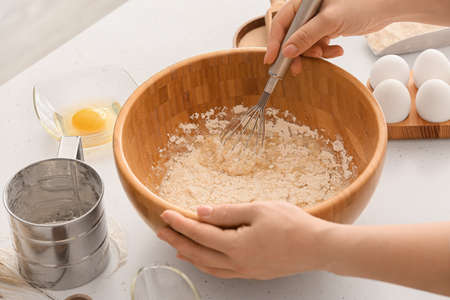 Female chef preparing dough on kitchen table, closeupの写真素材